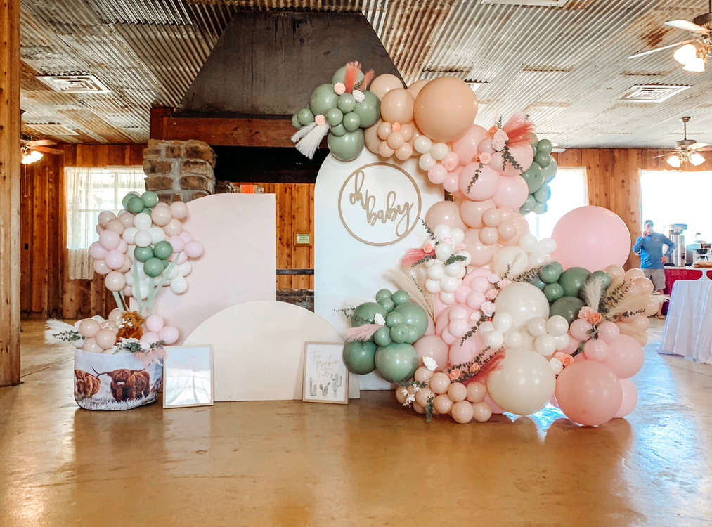 Panel Arches for rent that are accented by beautiful balloon garlands for a boho baby shower theme. 